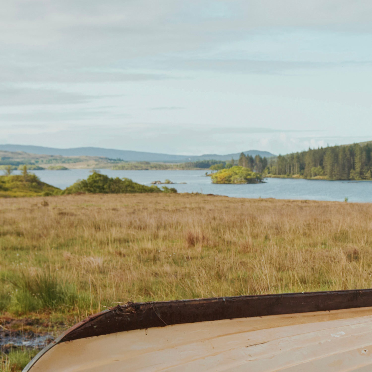 Irish landscape image with blue skies, mountains, forest, and a lake.//© Dubarry of Ireland