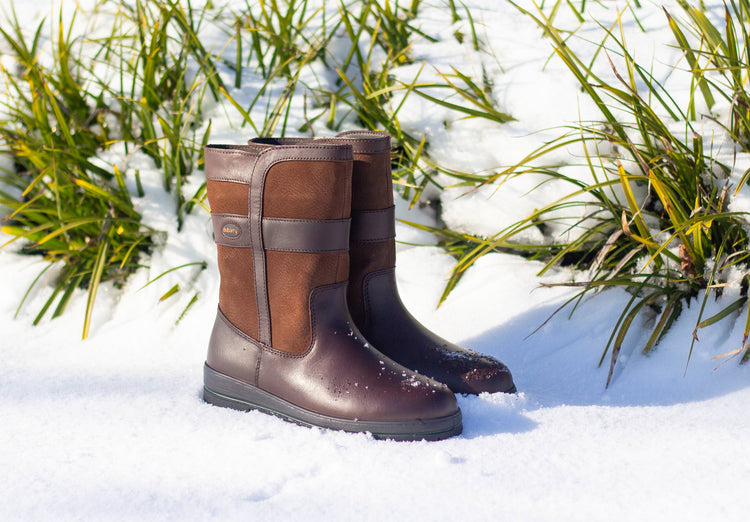 Pair of Dubarry Mens Roscommon Country Boots, walnut brown short leather boots sitting in the snow