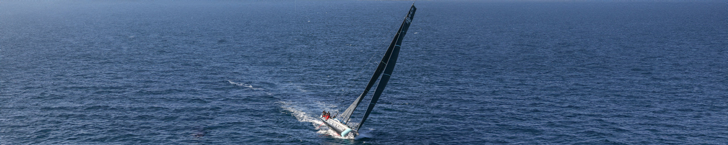 Wide image of the Team Mirpuri boat at sea